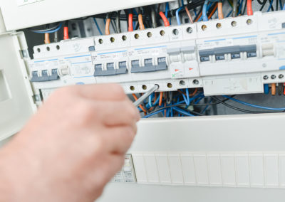 Electrician repairing a fuse